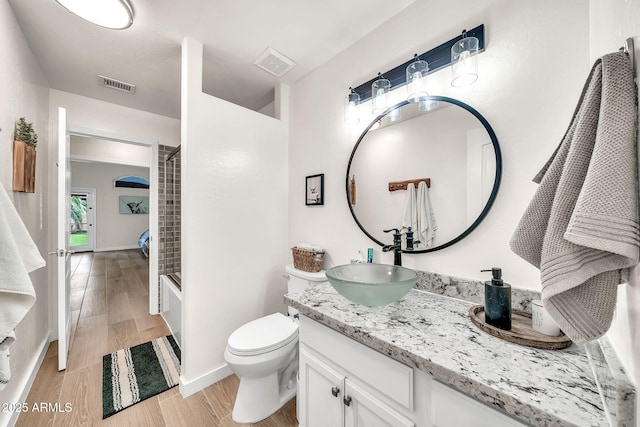 18644 N 21st St, Phoenix, AZ 85024 - bathroom with vanity, toilet, wood finished floors, shower / tub combination, and baseboards