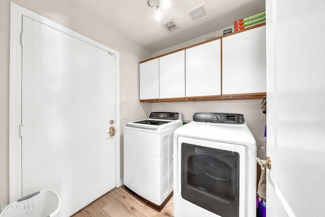 18644 N 21st St, Phoenix, AZ 85024 - laundry room with cabinet space, washer and clothes dryer, and light wood-type flooring