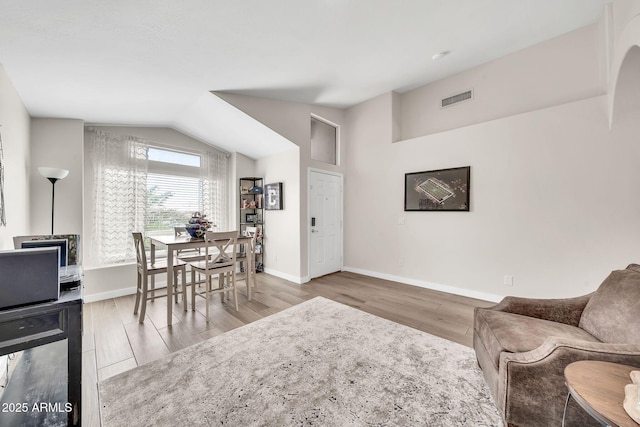 18644 N 21st St, Phoenix, AZ 85024 - living room featuring wood finished floors, baseboards, and lofted ceiling