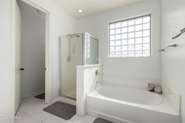 bathroom featuring plus walk in shower and tile patterned flooring