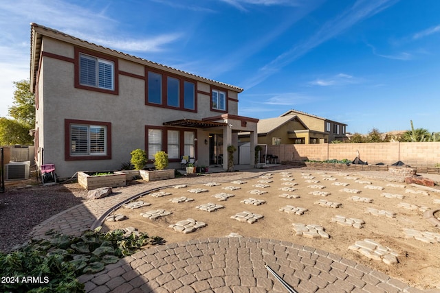 back of property featuring a patio area and central AC