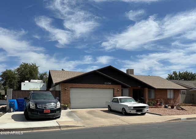3106 E Grove Ave, Mesa, AZ 85204 - view of front of home featuring driveway, an attached garage, brick siding, and roof with shingles