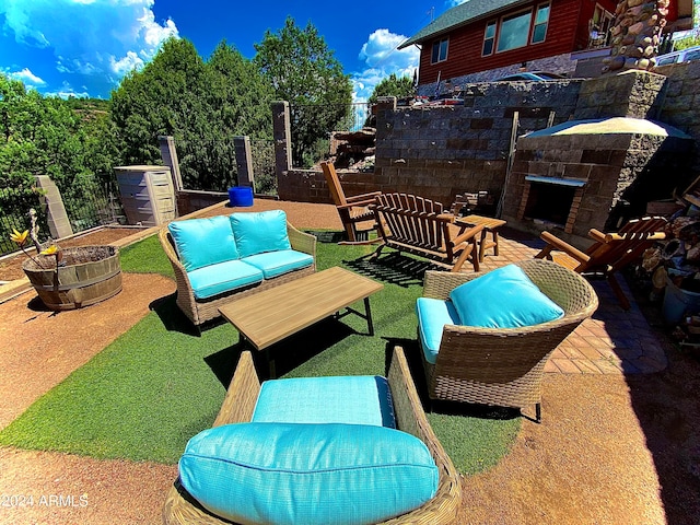 view of patio featuring an outdoor living space with a fireplace