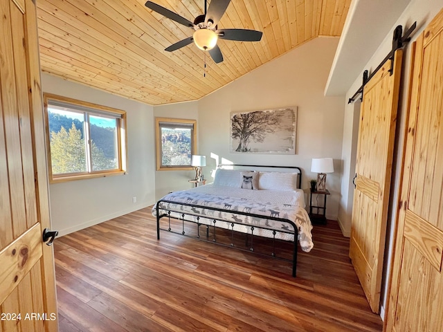 bedroom with wooden ceiling, a barn door, dark hardwood / wood-style floors, ceiling fan, and lofted ceiling