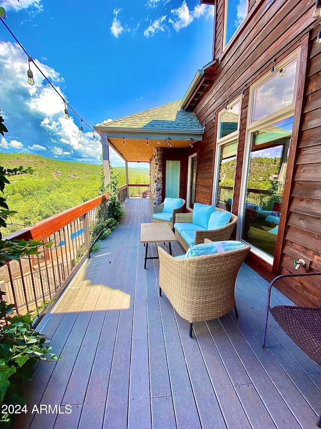 wooden terrace with an outdoor hangout area