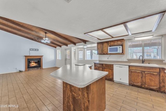 3046 E Dover St, Mesa, AZ 85213 - kitchen featuring white appliances, light countertops, ceiling fan, a kitchen island, and plenty of natural light