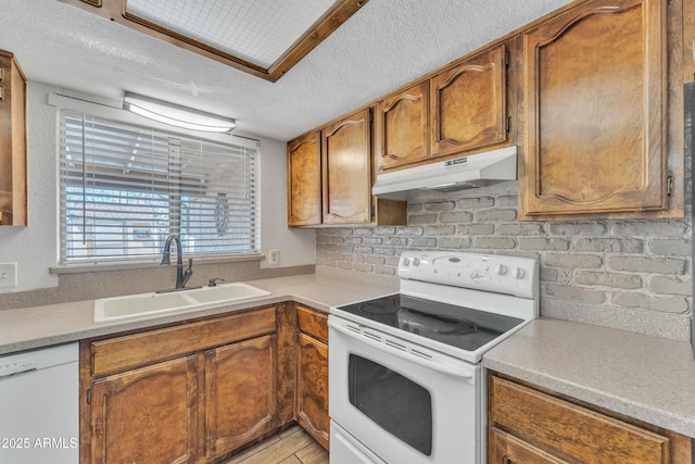 3046 E Dover St, Mesa, AZ 85213 - kitchen with white appliances, under cabinet range hood, a textured ceiling, light countertops, and brown cabinetry