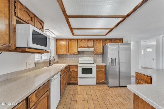 3046 E Dover St, Mesa, AZ 85213 - kitchen featuring white appliances, brown cabinets, under cabinet range hood, light wood-type flooring, and backsplash