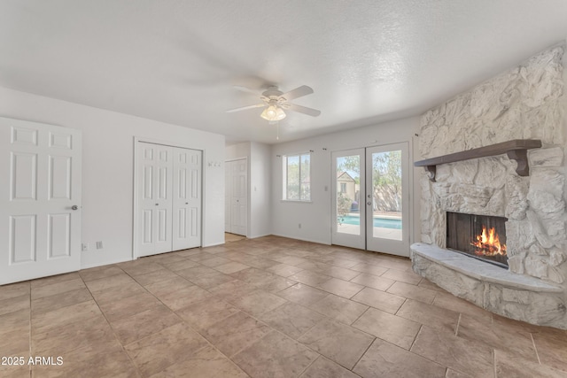 3046 E Dover St, Mesa, AZ 85213 - unfurnished living room featuring a ceiling fan, a stone fireplace, and french doors