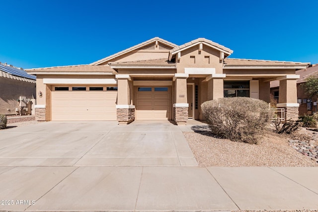 view of front of property featuring a garage, driveway, stone siding, and stucco siding