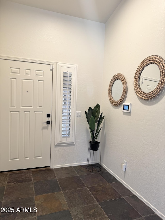 10341 E Dragoon Ave, Mesa, AZ 85208 - foyer featuring baseboards and dark stone finish flooring