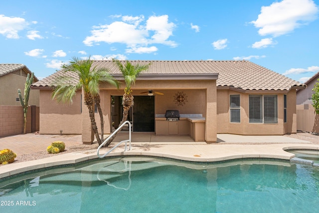 10341 E Dragoon Ave, Mesa, AZ 85208 - back of property with an outdoor kitchen, a ceiling fan, a tiled roof, stucco siding, and a patio