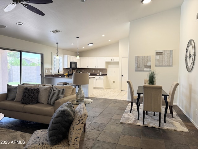 10341 E Dragoon Ave, Mesa, AZ 85208 - living room with vaulted ceiling, recessed lighting, stone tile flooring, and a ceiling fan