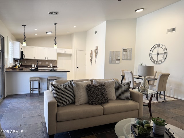 10341 E Dragoon Ave, Mesa, AZ 85208 - living room with vaulted ceiling, stone tile flooring, and recessed lighting
