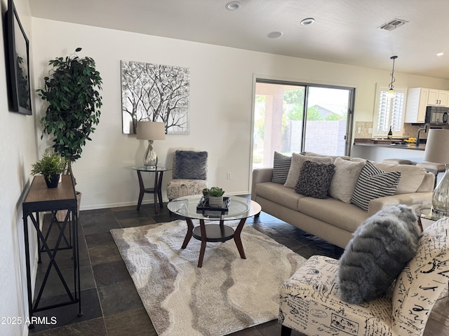 10341 E Dragoon Ave, Mesa, AZ 85208 - living area with dark stone finish floors and recessed lighting