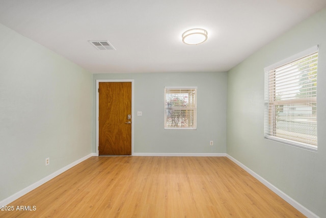 unfurnished room with light wood-type flooring