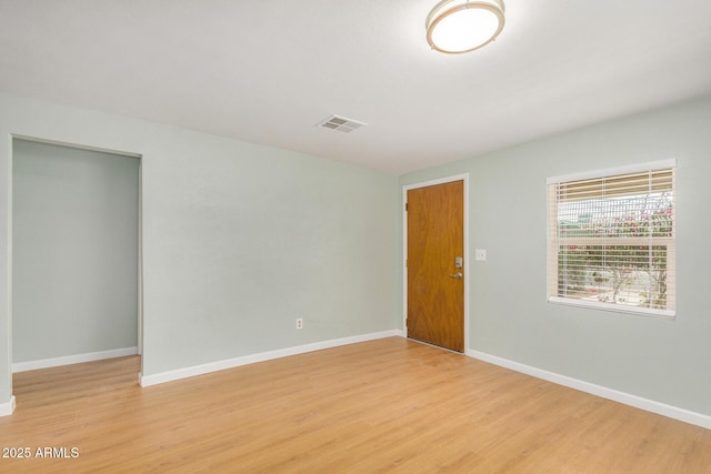 spare room with light hardwood / wood-style floors