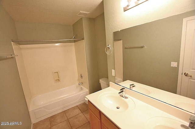 bathroom featuring tile patterned floors, tub / shower combination, double vanity, and a sink