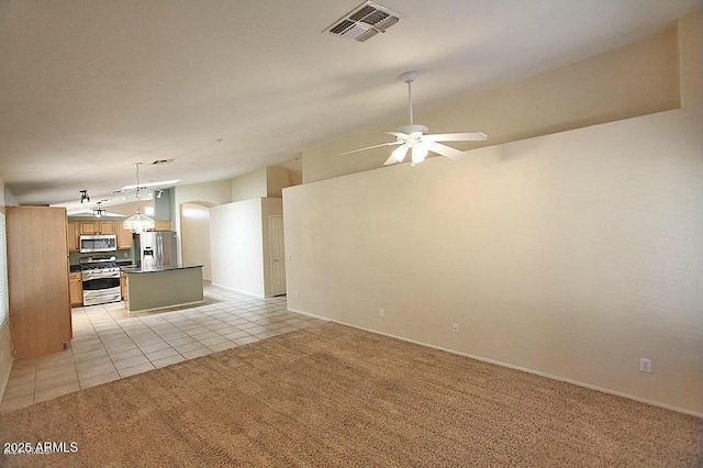 unfurnished living room featuring visible vents, light colored carpet, vaulted ceiling, light tile patterned floors, and a ceiling fan