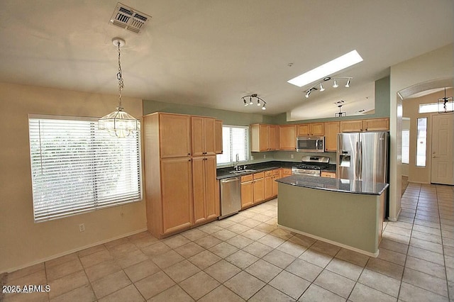 kitchen with visible vents, a sink, dark countertops, stainless steel appliances, and light tile patterned floors