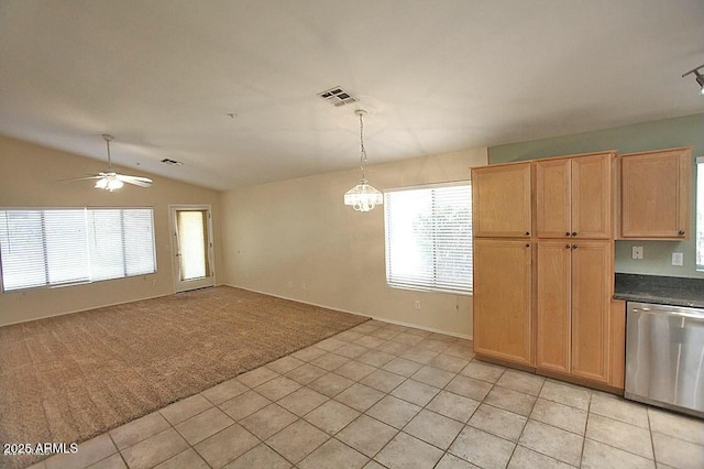 unfurnished dining area with light tile patterned floors, visible vents, vaulted ceiling, ceiling fan with notable chandelier, and light colored carpet