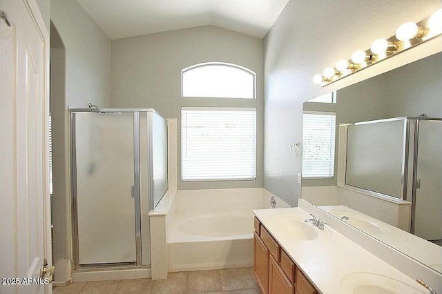 bathroom featuring a bath, tile patterned flooring, a shower stall, and a sink