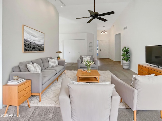 living room featuring track lighting and high vaulted ceiling