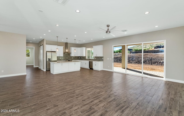 kitchen with pendant lighting, dark hardwood / wood-style floors, plenty of natural light, and a kitchen island