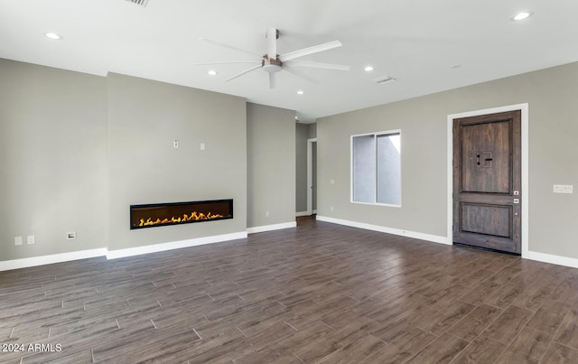 unfurnished living room featuring hardwood / wood-style floors and ceiling fan