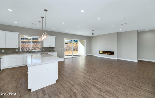 kitchen featuring a center island, a wealth of natural light, and white cabinets