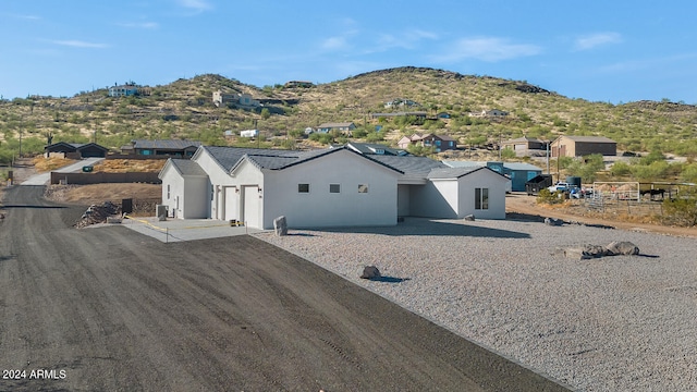 view of front facade with a mountain view and central AC unit