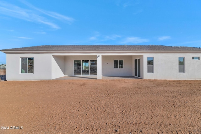 back of property with a patio