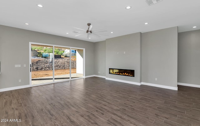 unfurnished living room featuring dark hardwood / wood-style floors and ceiling fan