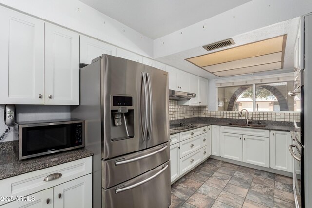 12811 N 44th Dr, Glendale, AZ 85304 - kitchen featuring stainless steel appliances, under cabinet range hood, a sink, and white cabinetry