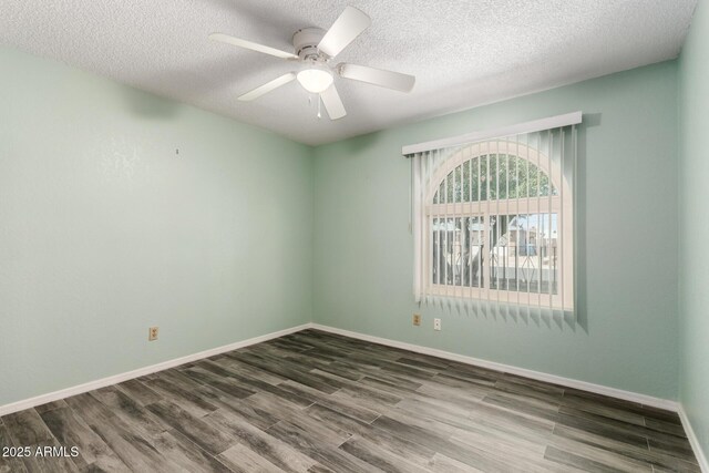 12811 N 44th Dr, Glendale, AZ 85304 - spare room featuring wood finished floors, a ceiling fan, a textured ceiling, and baseboards