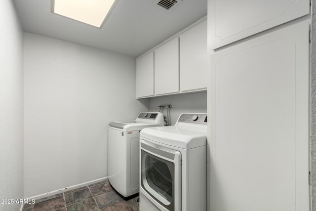 12811 N 44th Dr, Glendale, AZ 85304 - clothes washing area featuring cabinet space, separate washer and dryer, baseboards, and dark stone finish floors