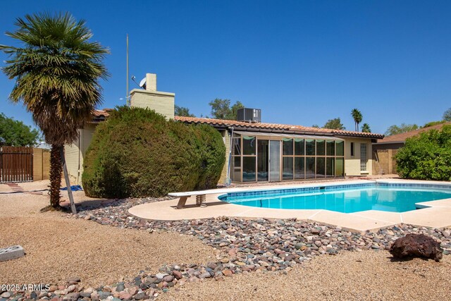 12811 N 44th Dr, Glendale, AZ 85304 - view of pool with fence, a patio area, a sunroom, central AC unit, and a diving board