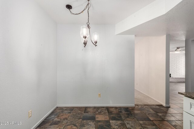 12811 N 44th Dr, Glendale, AZ 85304 - unfurnished dining area with baseboards, a chandelier, and stone finish floors