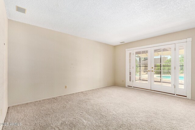 12811 N 44th Dr, Glendale, AZ 85304 - carpeted spare room featuring french doors, a textured ceiling, and baseboards