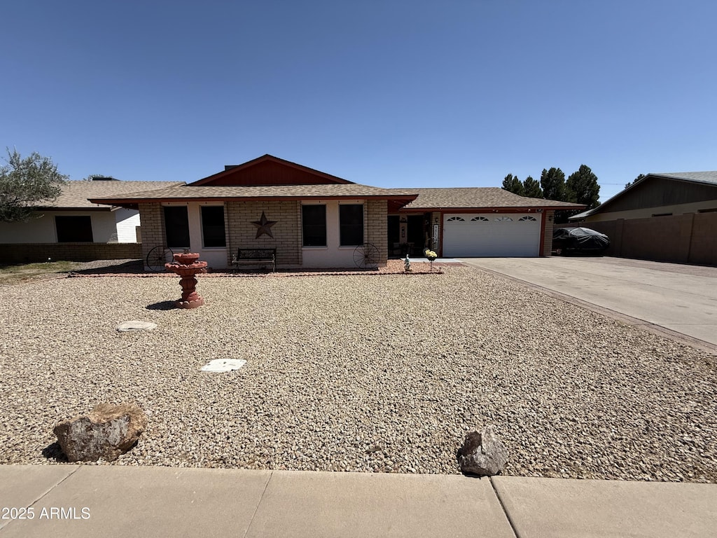 1557 W Posada Ave, Mesa, AZ 85202 - ranch-style house featuring a garage, concrete driveway, and brick siding