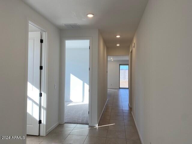 corridor with tile patterned flooring