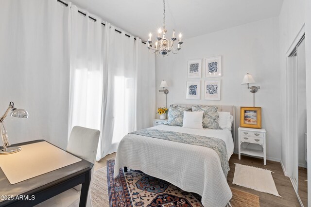 31032 N 66th St, Cave Creek, AZ 85331 - bedroom featuring a chandelier, wood finished floors, and baseboards