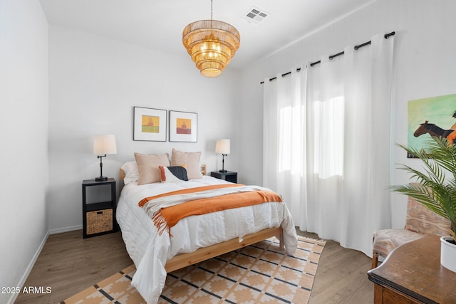 31032 N 66th St, Cave Creek, AZ 85331 - bedroom with a chandelier, light wood-style flooring, and baseboards