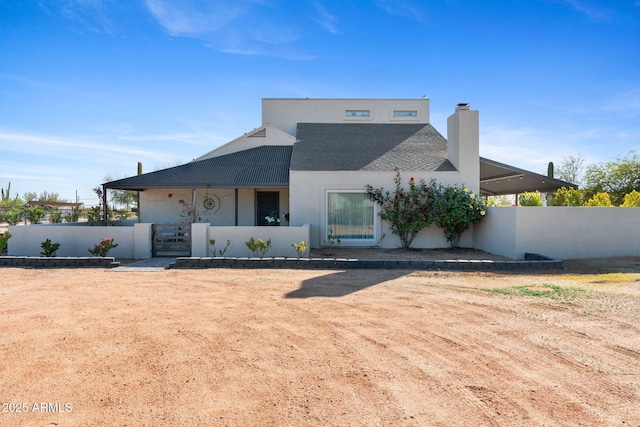 31032 N 66th St, Cave Creek, AZ 85331 - back of house with a chimney, stucco siding, a gate, and roof with shingles