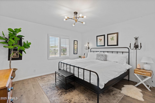 31032 N 66th St, Cave Creek, AZ 85331 - bedroom with a chandelier, wood finished floors, and baseboards