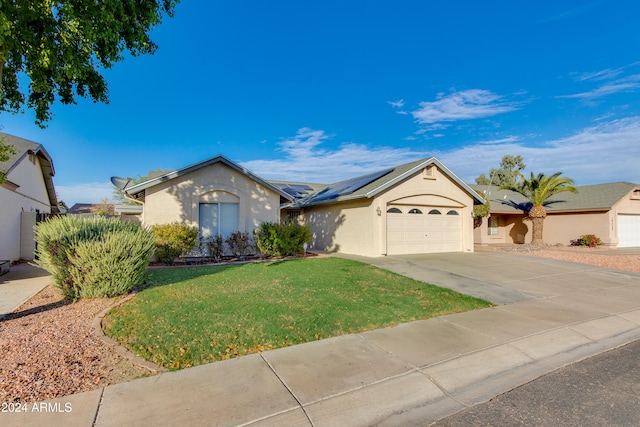 ranch-style home featuring a garage and a front yard