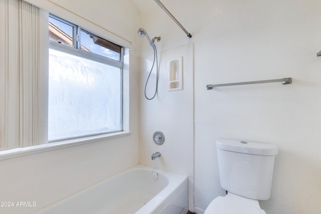 bathroom featuring bathing tub / shower combination and toilet