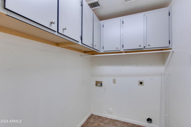 laundry room featuring cabinets, washer hookup, light tile patterned floors, and electric dryer hookup