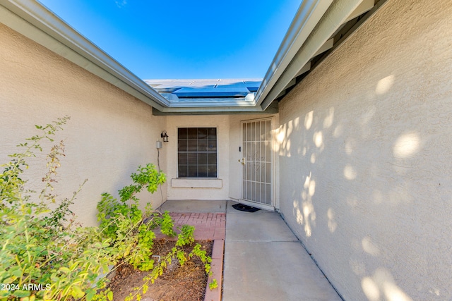 view of exterior entry featuring a patio