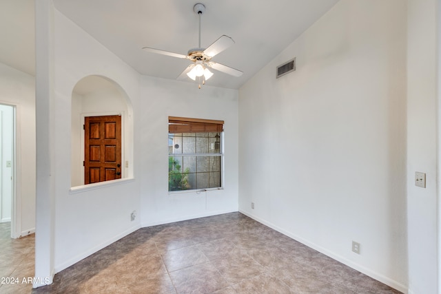 spare room with light tile patterned flooring, ceiling fan, and vaulted ceiling